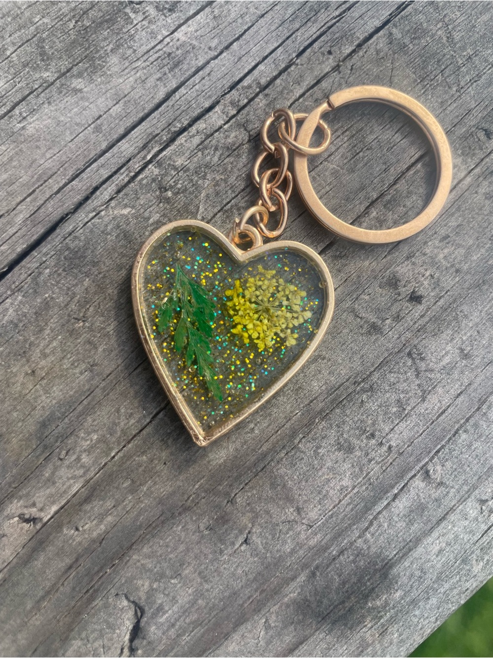 Gold Heart Keychain with Yellow Flower and Green Foliage
